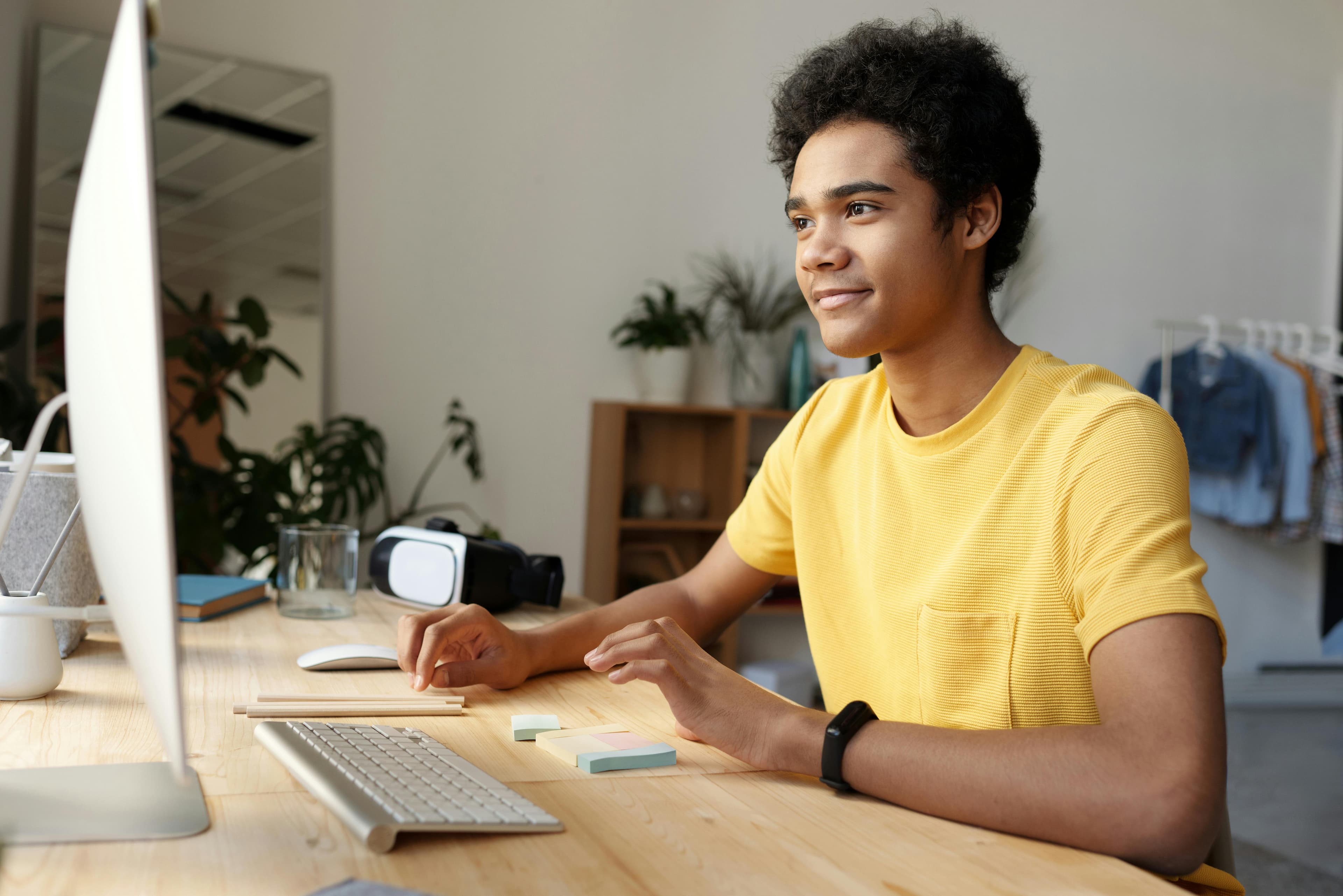 Student working on a laptop with guidance